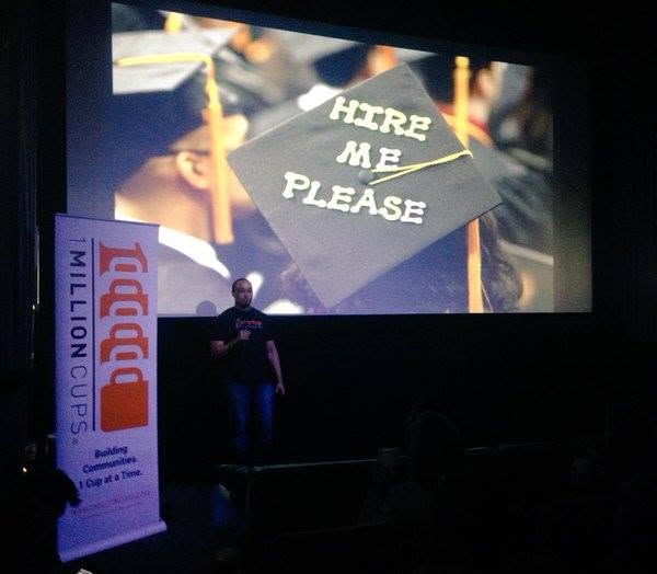 A Home Scene Pro presentation with a graduation cap reading Hire Me Please on the screen