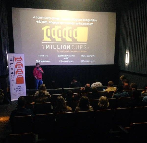 An audience in a theater during a 1 Million Cups startup presentation